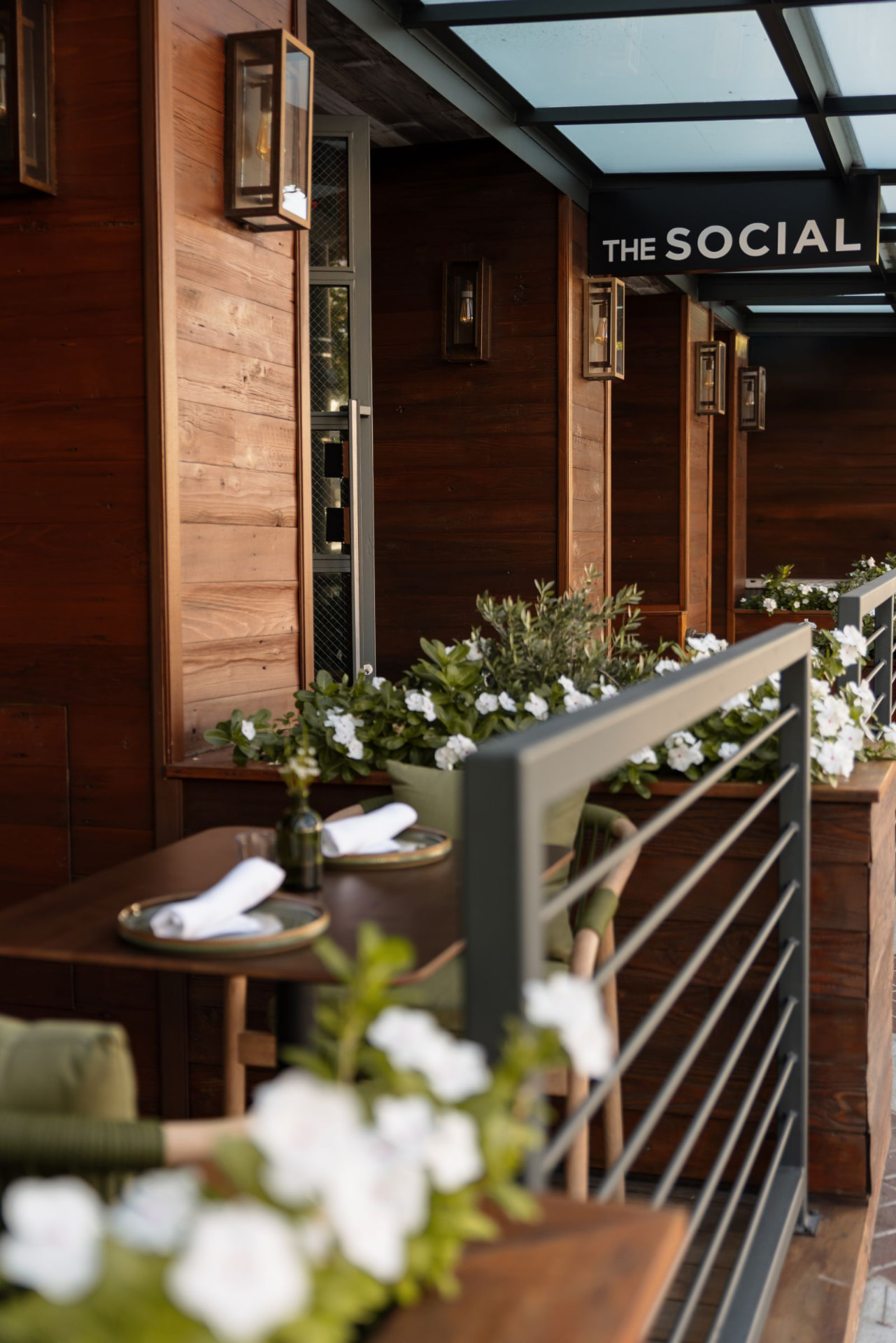 The Social's script patio sign glowing at dusk on N Brand Blvd